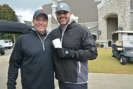 two middle-aged men standing outside of Greystone Golf & Country Club in the Fall